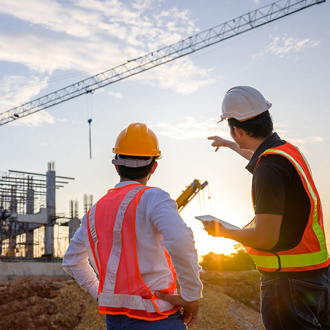 Two construction professionals discussing plans at a construction site