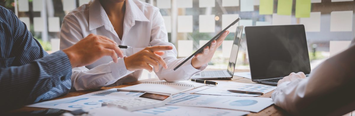 Two people are seated at a desk in a business consultation